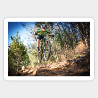 Close up image of a mountain biker getting air Sticker